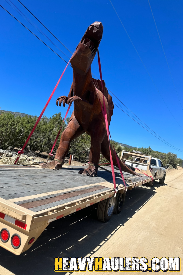 Transporting an oversize steel spinosaurus dinosaur.