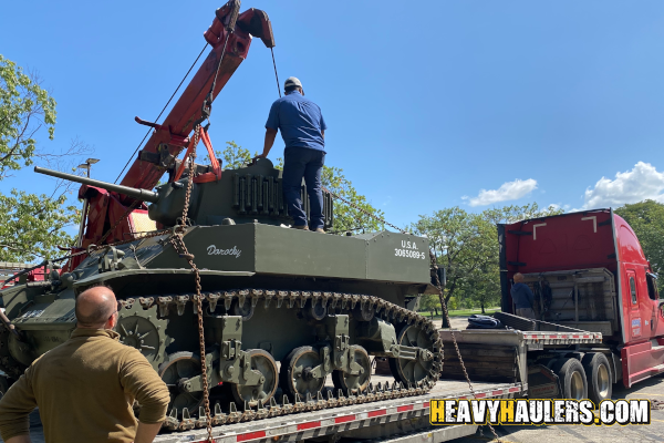 Securing a Stuart Tank to a step deck trailer.
