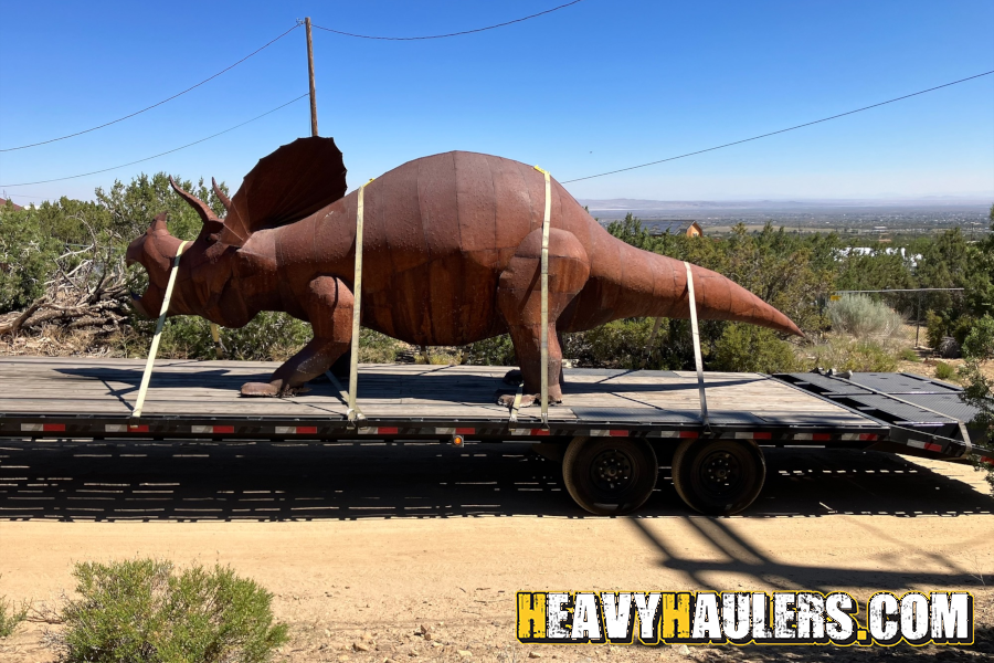 Steel triceratops loaded on a trailer. 