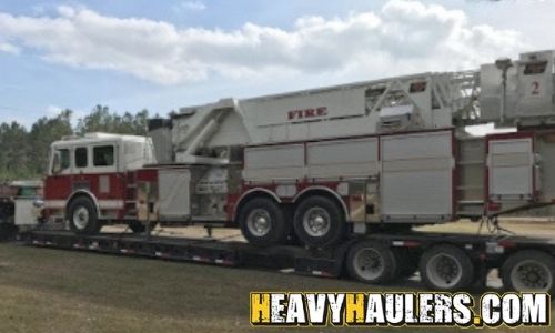 Hauling a fire truck on an RGN trailer.