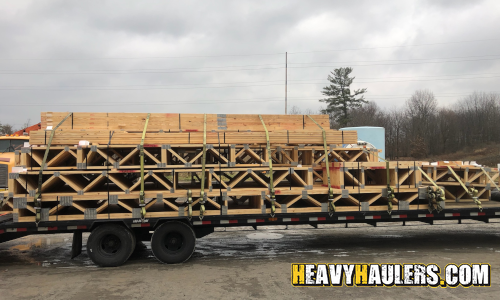 Shipping roof trusses on a flatbed trailer.