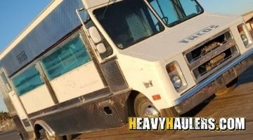 Loading a Chevy food truck on a trailer.