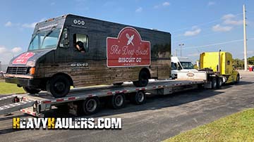 Chevy food tuck on a 6 axle flat bed trailer