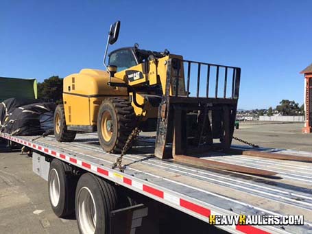 Telescopic Handler being transported on a flatbed trailer