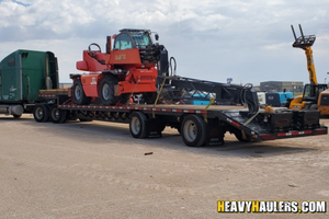 Manitou MRT 2540 telescopic forkflift on a trailer.