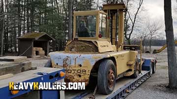 Transporting a vintage forklift.