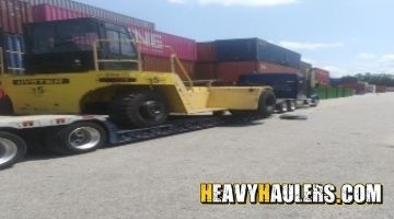 Hauling a forklift on an RGN trailer.