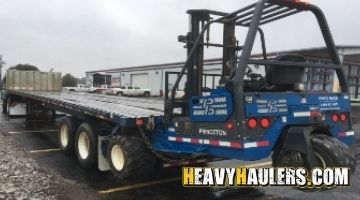 Loading a forklift on a trailer.