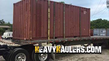 Shipping container loaded on a step deck