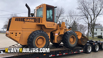 Case front loader being hauled.