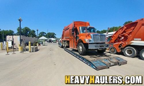 Loading an International garbage truck on an RGN trailer.