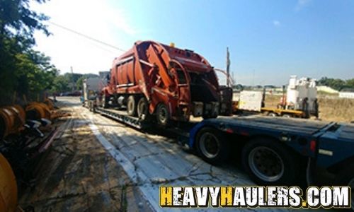 Shipping an International garbage truck on an RGN trailer.