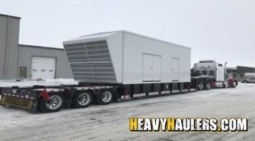 Oversize generator loaded on a stepdeck trailer.