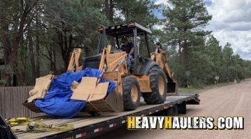 Transporting a Case 590 backhoe on a hotshot trailer.