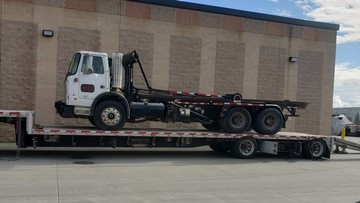 Loading a roll off truck on a trailer.