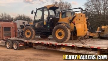 CAT Telehandler being shipped on a Flatbed