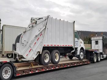 Hauling a Sterling Acterra on an RGN trailer.