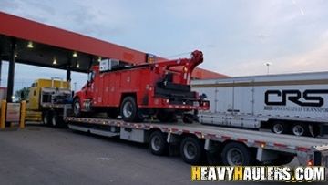 Hauling a service truck on a step deck trailer.