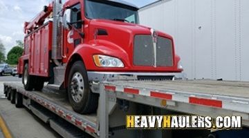 Kenworth service truck shipped on a stepdeck trailer.