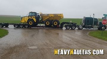 Loading a Komatsu articulated dump truck on an RGN trailer.