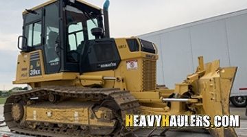 Loading a Komatsu bulldozer on a trailer.