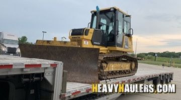 Shipping a Komatsu bulldozer on a stepdeck trailer.