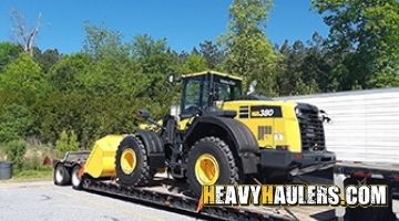 Loading a Komatsu wheel loader for transport.