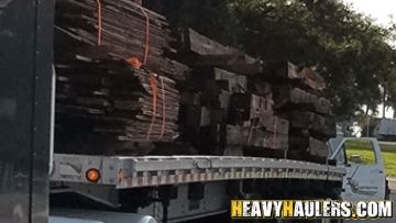 Lumber transported on a flatbed trailer.