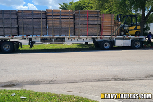 Transporting materials on a flatbed trailer.