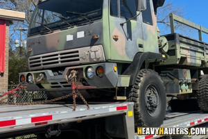 Hauling an M1078 LMTV cargo truck with armored cab.