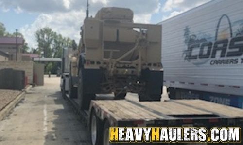 Hauling an MRAP military truck on an RGN trailer.