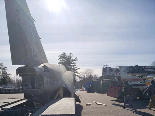Military plane tarnsport on a trailer.
