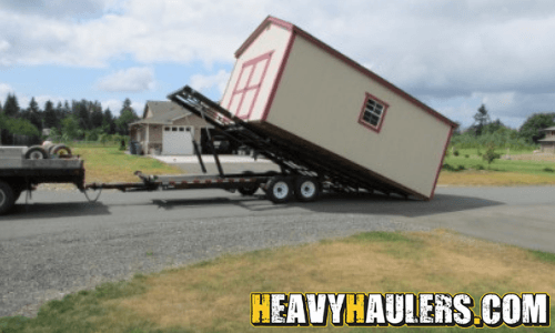 tan shed being moved