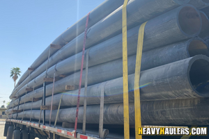 Banded HDPE pipes transport.