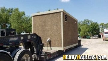 Mobile office transport on an RGN trailer.