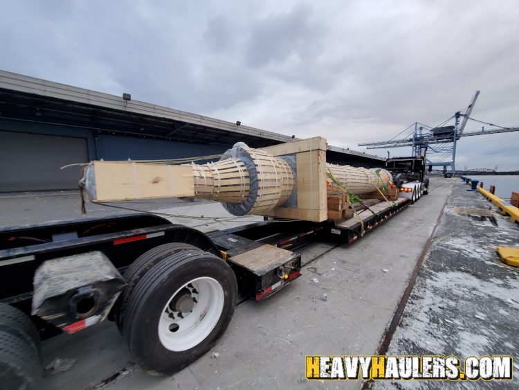 Hydraulic hoist hauled on a lowboy trailer.