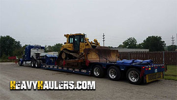 Crawler loader shipped on an RGN trailer.