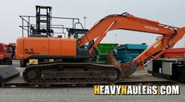 Loading a Hitachi excavator on an RGN trailer.