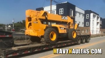 Hauling a JCB telehandler on an RGN trailer.