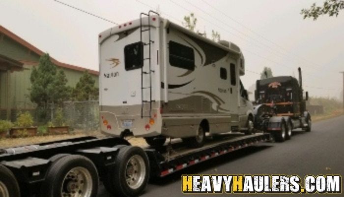Davion RV transport on a lowboy trailer.