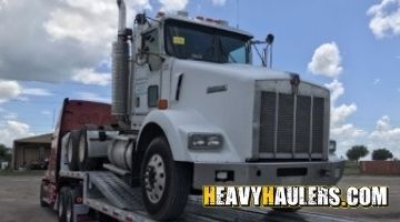 Transporting a Kenworth daycab on a stepdeck trailer.