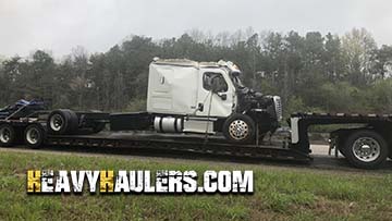 Inoperable Freightliner semi truck transport.