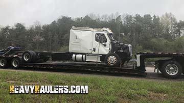 Hauling a Freightliner Cascadia daycab truck.