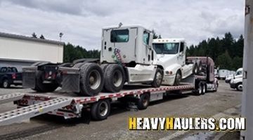 Loading Freightliner daycab truck on a stepdeck trailer for transort.
