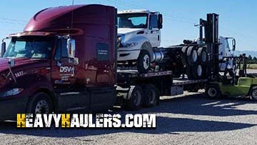 Loading International daycab trucks on a trailer.