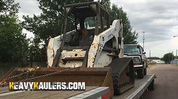 Hauling a Bobcat skid steer loader on a hotshot trailer.