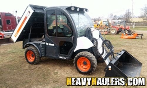 Hauling a Bobcat toolcar utility work tractor.