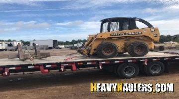 Transporting a John Deere skid steer loader.