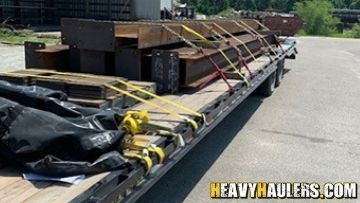 Steel beams hauled on a flatbed trailer.