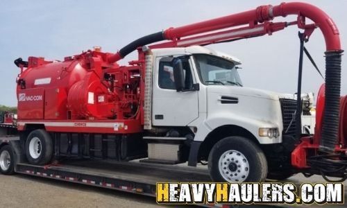 Transporting a Vac-Con Volvo tank truck.